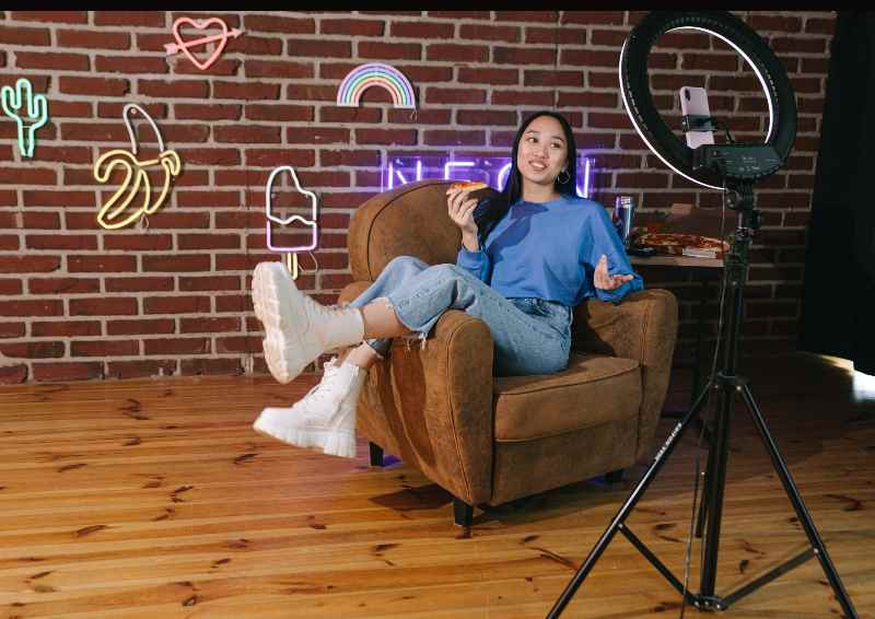 A woman sitting in a chair with her legs crossed.